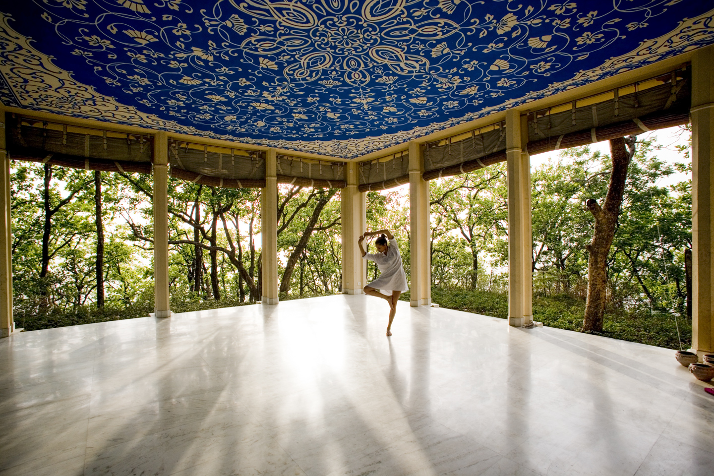 A woman performing yoga in the pavilion.