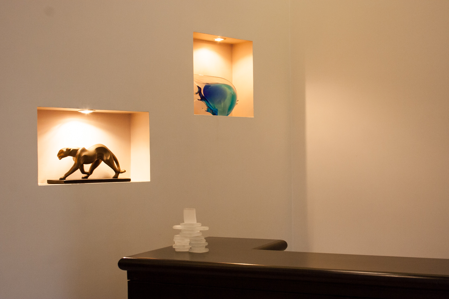 Sculptures in lit niches next to the bar