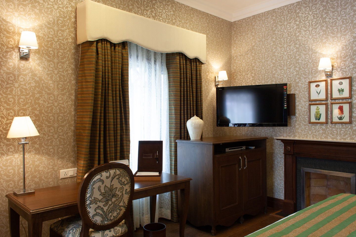 The TV swivels from the wall to be viewed from the bed or the seating area. The fireplace is edged with steel, surrounded by flamed granite and wood, and topped by marble.