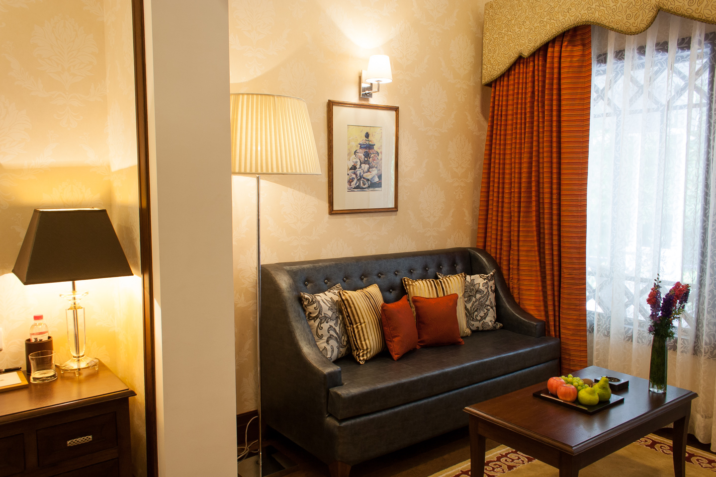 The leather sofa is placed next to the garden window.