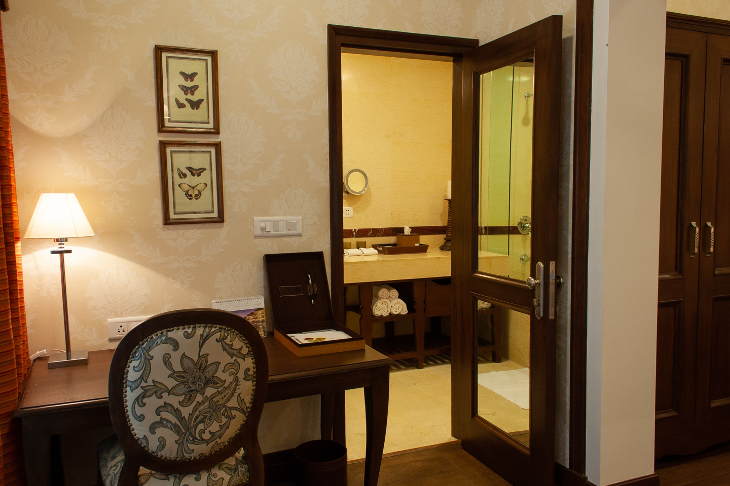 The desk next to the bathroom door.