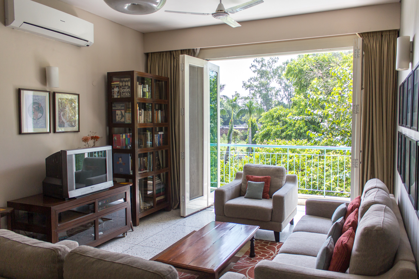 The drawing room connects well to the greenery outside through the folding doors.