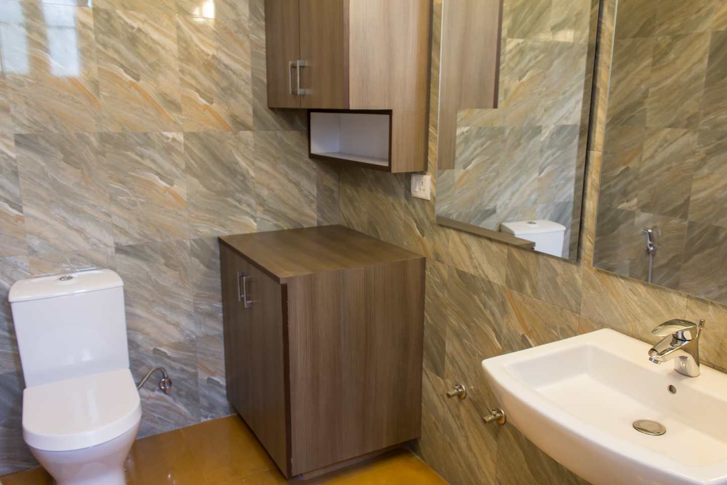 The guest bathroom is large and has provision for a washing machine. Cabinets accommodate buckets, washing powder and the like.